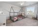 Bright bedroom with window and decorative house frame bed at 3036 Whipcord Dr, Waxhaw, NC 28173