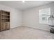 Empty bedroom featuring neutral carpet, light gray walls and window at 3036 Whipcord Dr, Waxhaw, NC 28173
