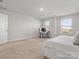 Spacious bedroom offers room for both relaxation and work, with two windows and a neutral color palette at 3036 Whipcord Dr, Waxhaw, NC 28173
