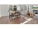 Dining area with wood table, chairs, large windows, and view to living room with fireplace at 3036 Whipcord Dr, Waxhaw, NC 28173