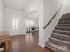 A stylish foyer features hardwood floors, a staircase, and an adjacent office space at 3036 Whipcord Dr, Waxhaw, NC 28173