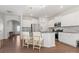 Open kitchen with an island and barstool seating, stainless steel appliances, and access to the dining area at 3036 Whipcord Dr, Waxhaw, NC 28173