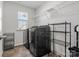 Well-equipped laundry room with shelving and modern appliances at 3036 Whipcord Dr, Waxhaw, NC 28173