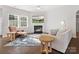 Inviting living room featuring a cozy fireplace and natural light from large windows at 3036 Whipcord Dr, Waxhaw, NC 28173
