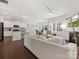 Open-concept living area with hardwood floors, fireplace, kitchen, and dining space at 3036 Whipcord Dr, Waxhaw, NC 28173