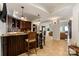 Entertain guests at the wet bar with a marble countertop, seating, and seamless access to the living room at 325 Ivy Arbor Cir, Rock Hill, SC 29732