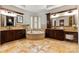 A luxurious bathroom boasts a round tub, double vanities, decorative mirrors, and travertine tile at 325 Ivy Arbor Cir, Rock Hill, SC 29732