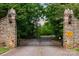 Stone gate entrance to a private community surrounded by lush greenery at 325 Ivy Arbor Cir, Rock Hill, SC 29732