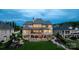 Large luxury home with lush landscaping, garden, hot tub, outdoor patio, and beautiful stone and brick elevation at 325 Ivy Arbor Cir, Rock Hill, SC 29732