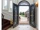 Grand foyer with a custom iron door, wooden staircase, and marble floors at 325 Ivy Arbor Cir, Rock Hill, SC 29732