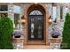 Elegant front entrance with custom iron double doors, brick archway, and stone accents at 325 Ivy Arbor Cir, Rock Hill, SC 29732