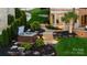 Backyard hot tub with manicured landscaping, walkway lighting and a glimpse of the main house at 325 Ivy Arbor Cir, Rock Hill, SC 29732