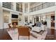 Bright open-concept living room featuring a fireplace, built-ins, and views of the dining area at 325 Ivy Arbor Cir, Rock Hill, SC 29732