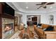 Inviting living room featuring a stone fireplace, leather seating, and a beautiful lake view at 325 Ivy Arbor Cir, Rock Hill, SC 29732