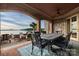Covered patio features brick archway, stone wall, ceiling fan, water view, and an elegant table and chairs set at 325 Ivy Arbor Cir, Rock Hill, SC 29732