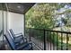 Relaxing balcony with two blue rocking chairs overlooking a green space at 3526 Saker Ln, Charlotte, NC 28211