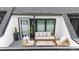 Relax on this cozy private balcony with modern furniture and charming decor at 3526 Saker Ln, Charlotte, NC 28211