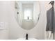 Contemporary bathroom features a round mirror, black hardware, and a patterned hand towel at 3526 Saker Ln, Charlotte, NC 28211