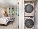 Cozy bedroom view with stacked washer and dryer in closet; perfect for convenient laundry access at 3526 Saker Ln, Charlotte, NC 28211