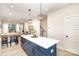 Spacious kitchen featuring a large island with seating, an open layout, and seamless flow to the dining area at 3526 Saker Ln, Charlotte, NC 28211