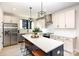 Bright kitchen with stainless steel appliances, white cabinetry, and island with seating at 3526 Saker Ln, Charlotte, NC 28211