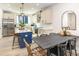 Open kitchen and dining area featuring stainless steel appliances, island seating, and modern fixtures at 3526 Saker Ln, Charlotte, NC 28211