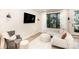 Bright living room featuring a large window, comfortable seating, and modern lighting at 3526 Saker Ln, Charlotte, NC 28211