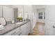 Well-lit bathroom featuring granite countertops, a modern sink, and a large mirror at 3708 Small Ave, Charlotte, NC 28269