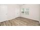 Bright bedroom featuring hardwood flooring, neutral walls, and ample natural light from large windows at 3708 Small Ave, Charlotte, NC 28269