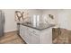 Modern kitchen island with granite countertop, ample storage, and barstool seating for casual dining at 3708 Small Ave, Charlotte, NC 28269