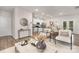 Open-concept living room with modern furniture, hardwood floors, and seamless access to the kitchen at 3708 Small Ave, Charlotte, NC 28269