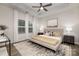 Comfortable main bedroom with neutral tones, tray ceiling, ceiling fan, and large windows for natural light at 3708 Small Ave, Charlotte, NC 28269