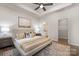 Spacious main bedroom featuring a tray ceiling, ceiling fan, ensuite bathroom, and a walk-in closet at 3708 Small Ave, Charlotte, NC 28269