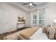 Inviting bedroom featuring large windows, a comfortable bed, neutral tones, and a stylish console table at 3708 Small Ave, Charlotte, NC 28269