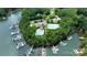 Aerial view of a community clubhouse with a pool, tennis court, boat docks, and parking at 3988 Channel Point Ln, Denver, NC 28037