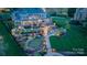 Backyard oasis with a putting green, tiered landscaping, a patio, a spa, and an outdoor living area with nighttime lighting at 3988 Channel Point Ln, Denver, NC 28037