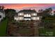 Expansive backyard with a putting green, tiered landscaping, a patio, and an outdoor living area at 3988 Channel Point Ln, Denver, NC 28037
