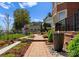Landscaped backyard with brick pathway, stone fountain, and lush garden beds at 3988 Channel Point Ln, Denver, NC 28037