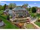 Beautiful backyard with a putting green, tiered landscaping, a patio, and an outdoor living area at 3988 Channel Point Ln, Denver, NC 28037