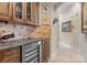Elegant bar area with wine cooler, granite countertop, and rich wood cabinetry; perfect for entertaining at 3988 Channel Point Ln, Denver, NC 28037