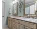 Well-lit bathroom with double sinks, granite countertops, decorative mirrors, and stylish fixtures at 3988 Channel Point Ln, Denver, NC 28037