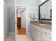 Bright bathroom featuring a granite vanity, large mirror, and convenient access to other rooms at 3988 Channel Point Ln, Denver, NC 28037