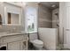 Modern bathroom featuring a tiled walk-in shower, granite vanity and ample natural light at 3988 Channel Point Ln, Denver, NC 28037