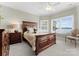 Inviting bedroom with large windows overlooking the lake, a ceiling fan, and traditional furnishings at 3988 Channel Point Ln, Denver, NC 28037