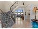 Grand foyer showcasing a curved staircase with decorative railing and open access to living areas at 3988 Channel Point Ln, Denver, NC 28037