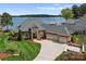 Stately brick home with a circular driveway, three-car garage, and beautiful landscaping, showcasing curb appeal at 3988 Channel Point Ln, Denver, NC 28037