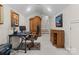 This home office features neutral walls, a black desk, and ample storage solutions for a productive workspace at 3988 Channel Point Ln, Denver, NC 28037