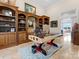 Stylish home office with custom built-ins and a unique, aviation-themed glass top desk at 3988 Channel Point Ln, Denver, NC 28037