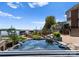 Backyard featuring a hot tub, outdoor kitchen, putting green, and lake access with boat docks at 3988 Channel Point Ln, Denver, NC 28037