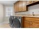 Well-organized laundry room with granite countertops, cabinets, and modern washer and dryer at 3988 Channel Point Ln, Denver, NC 28037